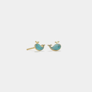Pair of turquoise whale-shaped earrings on a light gray background
