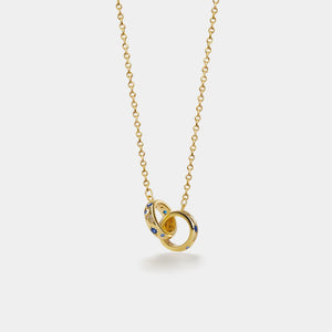 Gold necklace with interlocking rings pendant on a white background