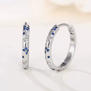Blue and clear cz butterfly huggie hoop earrings in 925 sterling silver with polished finish and hinged closure