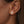 Model wearing sterling silver poodle stud earrings with pavé-set clear stones