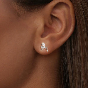 Model wearing sterling silver poodle stud earrings with pavé-set clear stones