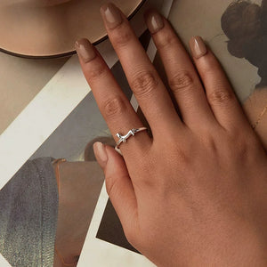 Model wearing a silver ring with a dachshund dog design