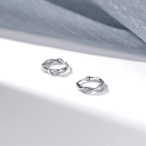 Silver hoop earrings on a light gray background