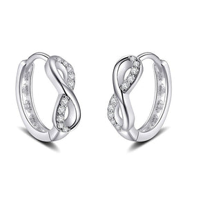 Pair of silver hoop earrings with small diamonds on a white background