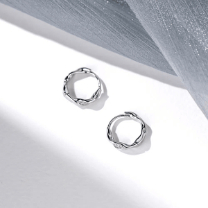 Silver hoop earrings on a light gray background