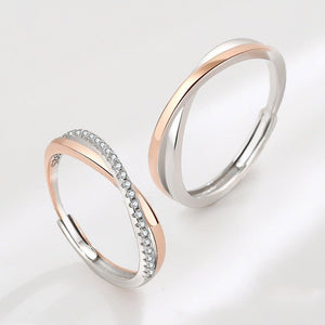 Two silver rings with rose gold accents on a light gray background