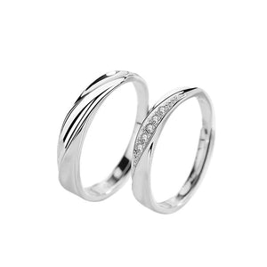 Two silver rings with diamond accents on a white background
