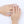 Close-up of a hand wearing silver rings on a white background