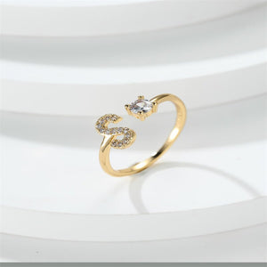 Gold ring with diamond accents on a white background