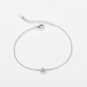 A sterling silver adjustable chain bracelet with a lobster clasp closure, featuring a hypoallergenic finish and gold plating.