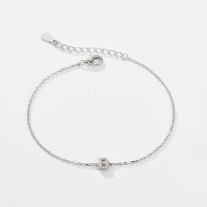 A sterling silver adjustable chain bracelet with a lobster clasp closure, featuring a hypoallergenic finish and gold plating.