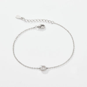 A sterling silver adjustable chain bracelet with a lobster clasp closure, featuring a hypoallergenic finish and gold plating.