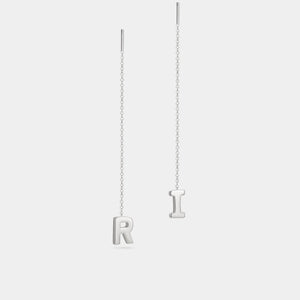 Silver letter 'R' and 'I' pendant necklace on a light gray background