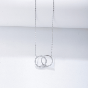 Silver necklace with interlocking rings on a light gray background