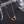 Rose gold necklace with a heart-shaped pendant on a dark background