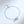 A matching set of interlocking ring bracelets, one with a black cord and another with a silver chain, laid on a white surface.