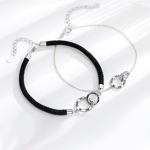 Necklace with black cord and silver clasp on a white background