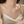 Pearl necklace on a person wearing a beige top