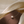 Pearl necklace on a brown surface with a soft beige fabric background
