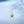 Necklace with a green teardrop pendant on a light blue background