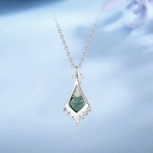 Necklace with a green teardrop pendant on a light blue background