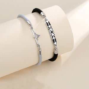 Two bracelets on a beige cushion with a neutral background