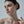 Close-up of a woman's neck and shoulders with a neutral background