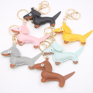 Set of colorful dachshund-shaped keychains on a white background