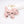 Pink dog-shaped keychain with black details on a white background