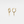 Gold hoop earrings with lightning bolt charms on a light gray background