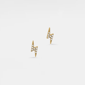 Gold lightning bolt earrings with clear gemstones on a light gray background