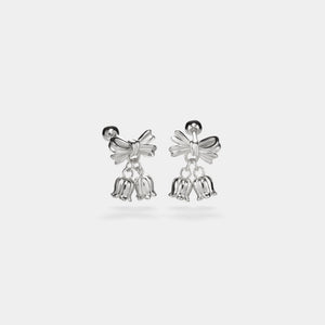 Silver bell-shaped earrings on a light gray background