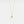 Gold necklace with a bell pendant on a light gray background