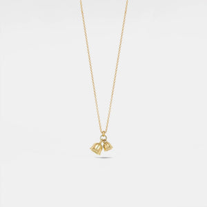 Gold necklace with a bell pendant on a light gray background