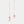 Rose gold bell-shaped earrings on a light gray background
