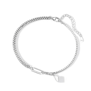 A sterling silver bracelet with a heart-shaped design and a chain structure, displayed on a white surface.