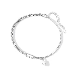 A sterling silver bracelet with a heart-shaped design and a chain structure, displayed on a white surface.