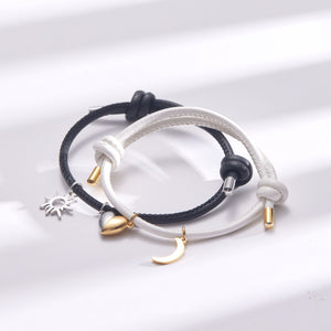 Two bracelets with charms on a white background