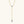Gold necklace with a blue gemstone pendant on a white background