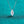 Silver necklace with a marquise-shaped diamond pendant on a teal background