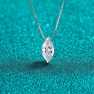Silver necklace with a marquise-shaped diamond pendant on a teal background