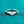 Silver ring with a heart-shaped diamond on a teal textured background