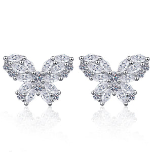 Butterfly-shaped earrings with clear gemstones on a white background