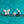 Butterfly-shaped silver earrings on a teal glittery background