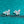 Butterfly-shaped earrings on a teal glittery background