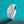 Silver ring with a large central moissanite on a turquoise glittery background