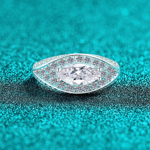 Teardrop-shaped moissanite ring with a turquoise glittery background