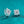 Silver flower-shaped earrings on a teal background