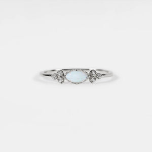Silver ring with a light blue gemstone on a white background