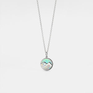 Necklace with a round pendant featuring a colorful gemstone on a light gray background